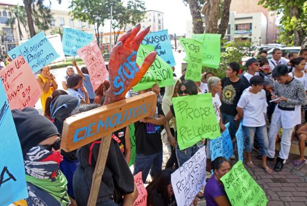 Settlers in Dona Pepang Cemetery hold placards in a protest before the Cebu City Hall after their houses were demolished as the cemetery will be converted into a park. (CDN PHOTO/ LITO TECSON)