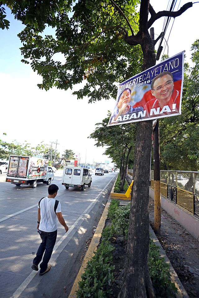 FREEDOM OF EXPRESSION/OCT.12,2015:A poster of Davao City Mayor Rodrigo Duterte and Senator Peter Allan Cayetano were placed in a tree in S Osmeña north reclamation. these practice is not illegal and falls under 'freedom of expression" according to COMELEC (CDN PHOTO/LITO TECSON)