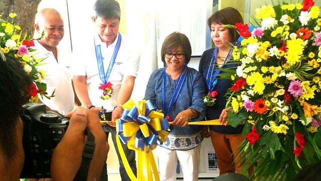Santa Fe Mayor Jose Esgana (left) and  DTI-7 Regional Director Asteria Caberte in a ribbon cutting during the launching of Negosyo Center in Santa Fe last May 19. (Contributed photo by Vladimir Castillo)