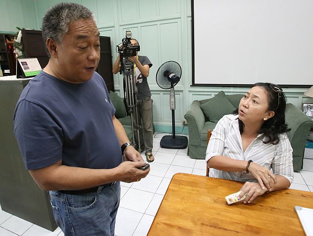 Cebu Gov. Hilario Davide III and UP Cebu Dean Liza Corro discuss the resolution of the land dispute between the school and the settlers of Sitio Avocado who occupy a portion of the school lot after their homes were destroyed by fire in these December 2015 file photos.