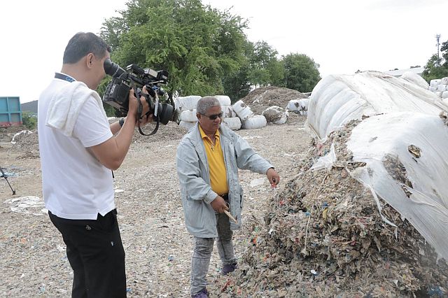 Acting Cenro chief Placido Jerusalem inspects the plastic wastes dumped in a private lot near the Butuanon River.  Contributed Photo/Mandaue CIO