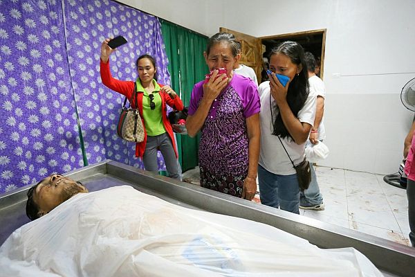 Ma. Norma Melloria, mother of ASG Leader Joselito Melloria, shed tears while watching the body of his son at the Clarin Funeral Homes in Clarin, Bohol./ Junjie Mendoza