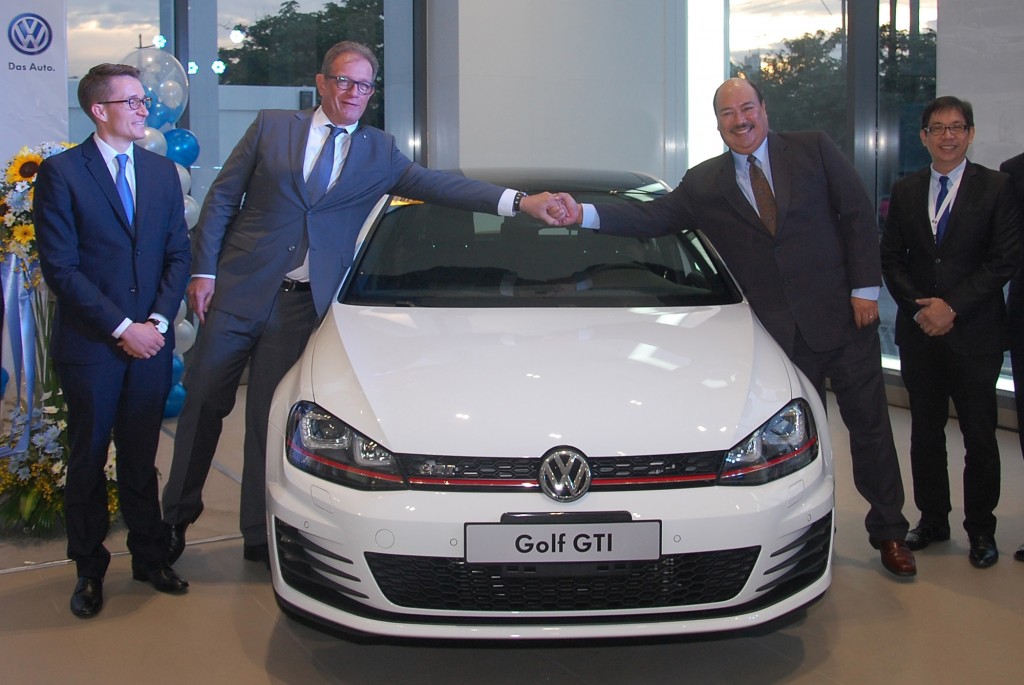 VW officials (from left) Joerg Andrischock, Llemens Roettgen, John Philip Orbeta and Tito Solomon with the Volkswagen Golf GTi during the launch of the VW Cebu dealership last Friday.  CDN PHOTO/CHRISTIAN MANINGO