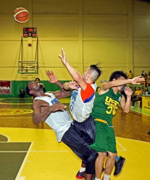 Southwestern University import Landry Sanjo (left) collides with teammate JR Parker while going up for a rebound against a University of San Carlos player in the championship game of the Asian University Basketball Championship yesterday at the Cebu City Sports Institute. ( CDN PHOTO/LITO TECSON)