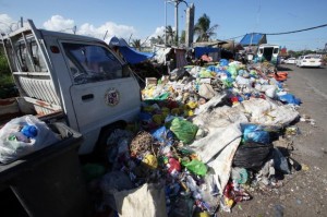 A mini cargo multicab that was used to collect garbage now stands along with the piles of uncollected garbage in barangay Guizo.  (CDN Photo/Junjie Mendoza)