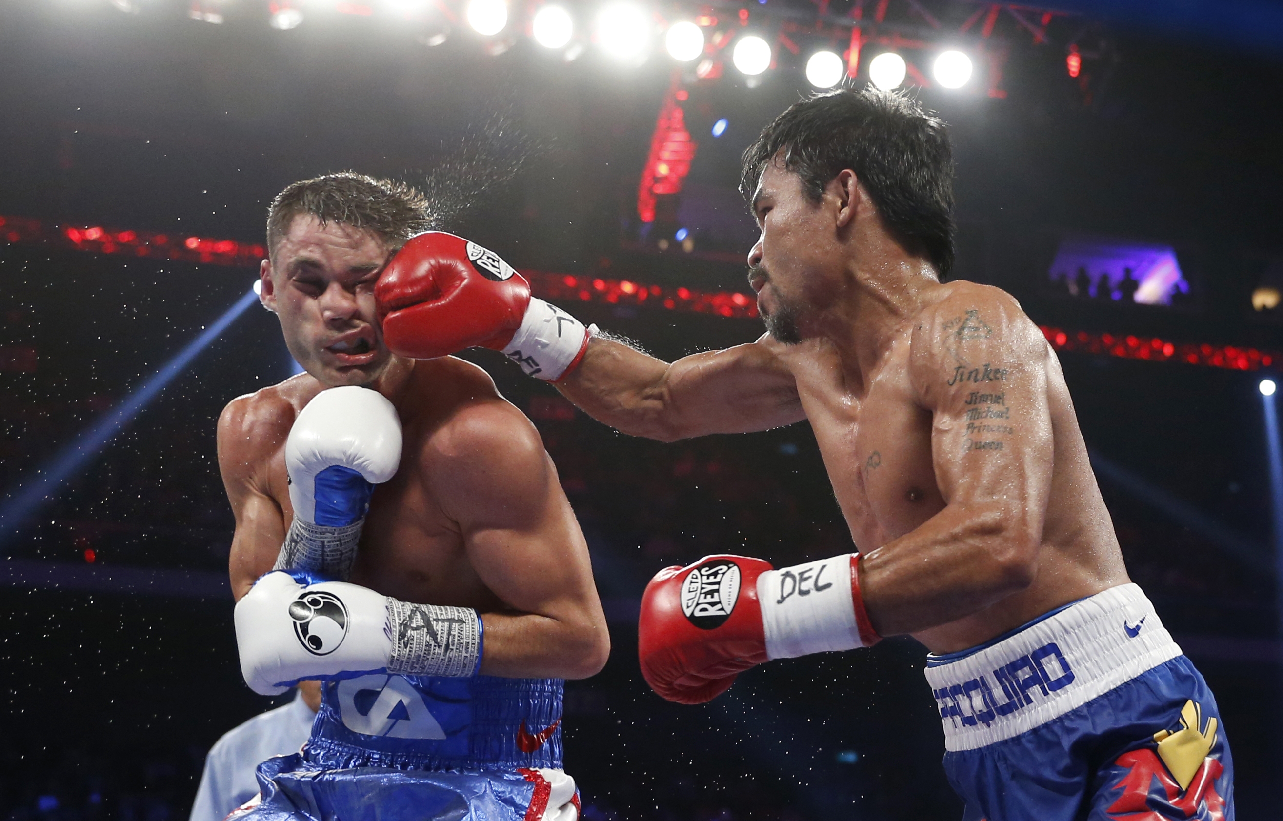 WBO welterweight champion Manny Pacquiao of the Philippines  batters WBO junior welterweight champion Chris Algieri of the U.S. in their world welterweight title boxing match at the Venetian Macao in Macau. (AP PHOTO)