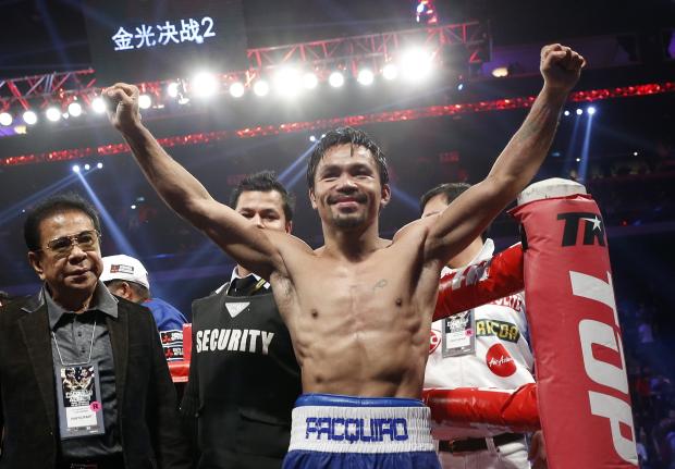 WBO welterweight champion Manny Pacquiao celebrates after defeating WBO junior welterweight champion Chris Algieri of the United States at the Venetian Macao in Macau. (AP PHOTO)