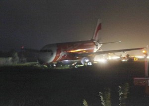 An AirAsia passenger plane sits on the grassy portion of the runway after overshooting upon landing in windy weather at Kalibo airport in Kalibo, Aklan last Tuesday. (AP Photo/ Jun Aguirre)