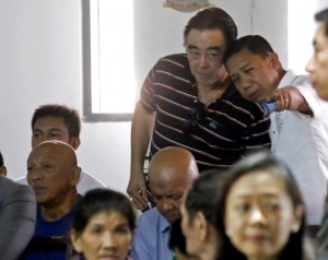 Former Guadalupe barangay Captain Eugenio "Jing Jing" Faelnar (standing, r ight) confers with his lawyer Atty. Julius Ceasar Entice before the arraingment of his graft case for  alleged misuse of about P6.5 million in pork barrel funds in the sala of RTC Judge Estela Singco. (CDN PHOTO/JUNJIE MENDOZA)