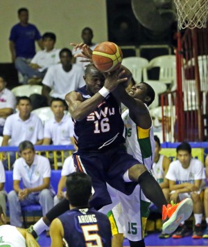 Landry Sanjo of SWU secures a rebound in this 2013 photo of a Cesafi game at the Cebu Coliseum. Sanjo will part ways with the Cobras and will be prelaced by another import. (CDN PHOTO/LITO TECSON)