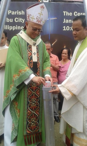 Cebu Archbishop Jose Palma places some San Pedro Calungsod memorabilia in a time capsule during the groundbreaking ceremony. (CDN Photo/Michelle Padayhag)