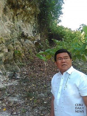 Cebu City Vice Mayor Edgar Labella with the entrance to the Buhisan Caves at the background.  (CDN Photo/Nestle L. Semilla)