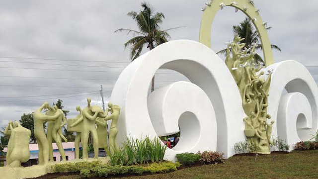 A memorial  for victims of supertyphoon Yolanda rises in Tanauan, Leyte province  designed by Davao-based artist  Rey Mudjahid “Kublai” Millan. (Right) New Stations of the Cross made of fiberglass are turned over by  Smart Communications to Palo Archbishop John Du. /Contributed photo