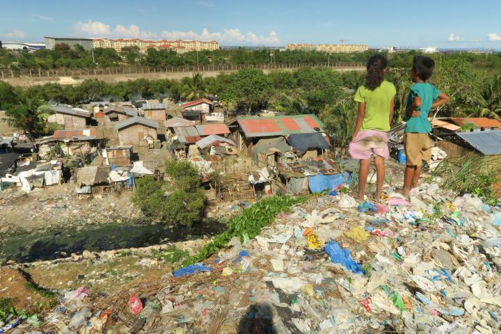 Children stand atop a mound of garbage overlooking their community of garbage pickers in Inayawan and farther ahead, condos rising in the South Road Properties. The piles reach as high as 20 meters. (CDN PHOTO/ TONEE DESPOJO)