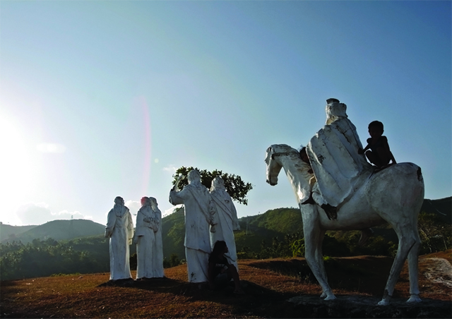  Children play amid the life-size statues in the  Tanchan Celestial Garden in Banawa, Cebu City where many faithful go to pray the Stations of the Cross as the Holy Week enters its most solemn days.   Here images of  Mary of Magdalene and disciples walk while a Roman soldier rides a horse to the Tenth Station. CDN PHOTO/JUNJIE MENDOZA
