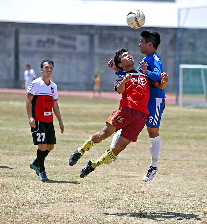 Timex and Convergys booters soar for the ball in their Aboitiz Football Cup game at the Ateneo de Cebu football field in Mandaue City.  (CDN PHOTO/LITO TECSON)