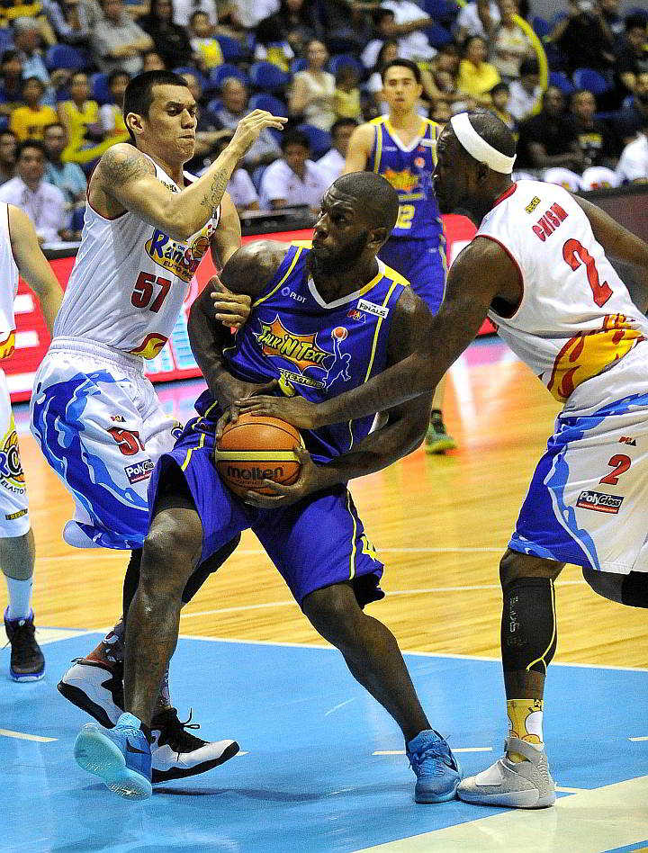 Rain or Shine’s Raymond Almazan (57) and Wayne Chism (2) gang up on Talk ‘N Text import Ivan Johnson in Game 2 of their best-of-seven championship series. (INQUIRER PHOTO)