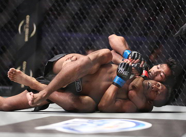 Cebuano Eugene Toquero tries to finish off Indonesia’s Brianata Rosadhi with a rear naked choke in their One Championships fight last Friday at the Mall of Asia Arena. Toquero won the fight via technical knockout in the first round. (INQUIRER)