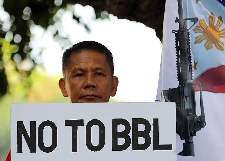 A man holds a placard expressing his opposition to the Bangsamoro Basic Law in a rally at the Luneta Park, Manila. (INQUIRER PHOTO)