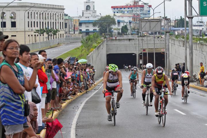 Hundreds of spectators watch from the roadside as Ironman 70.3 athletes, enter and exit from the SRP tunnel in August 2013. (CDN FILE PHOTO)