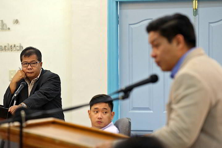 PB Member Peter John Calderon (left) listens to the questions posed by PB member Celestino Martinez III (right) on the payment of PhilHealth premiums.  (CDN Photo/Junjie Mendoza)