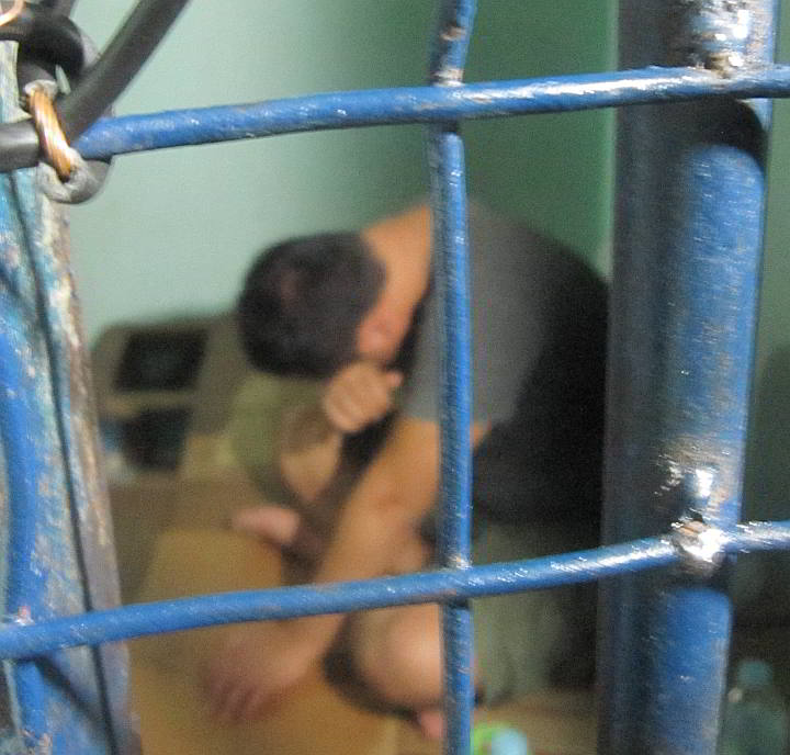 One of four Koreans  arrested on allegations of  human trafficking hides his face from news  cameras in the NBI detention cell. (CDN PHOTO/ADOR VINCENT V. MAYOL)