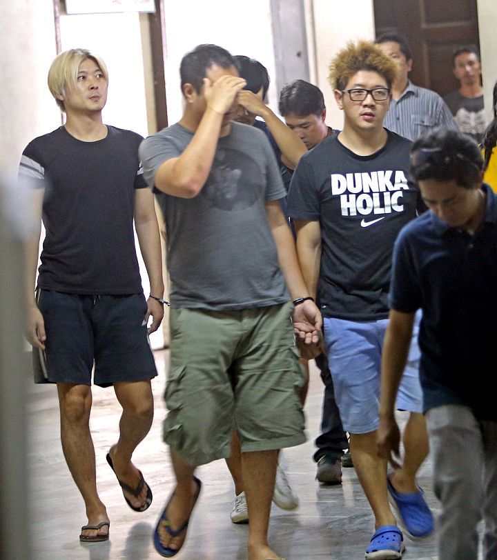 The four Koreans who were arrested last Thursday are brought to the prosecutors office during the filing of the human trafficking case against them, 