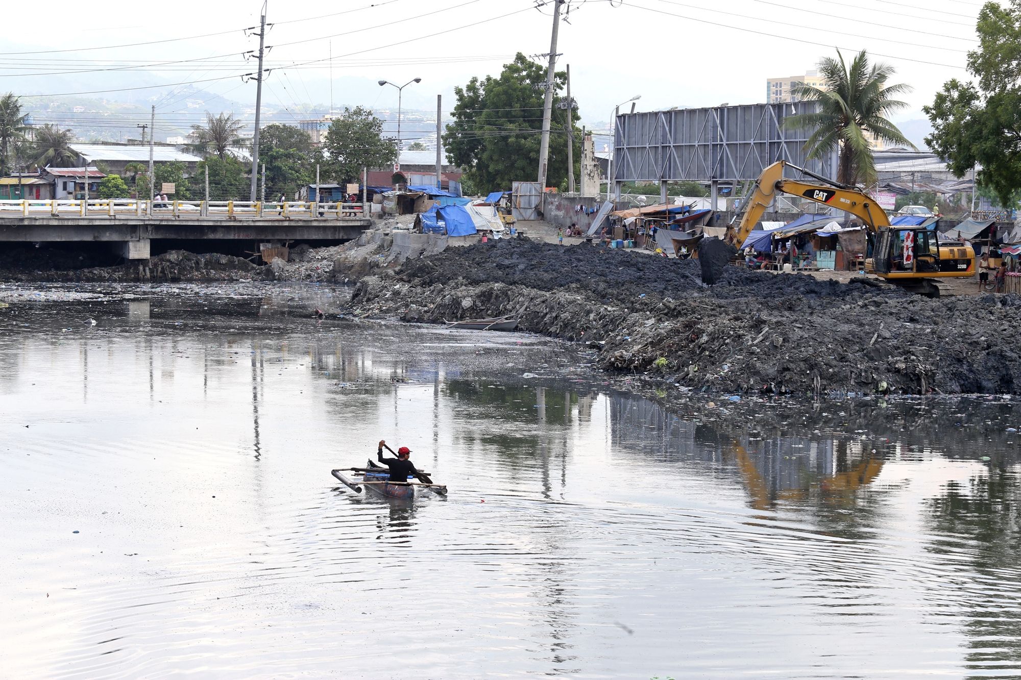 The Cebu City government dredges a part of the Mahiga creek.