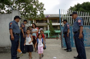 Policemen from the Waterfront Police Station are deployed at the Tejero Elementary School in Cebu City, in this June 2009 file photo, Police are gearing up for the opening of classes on Monday. 