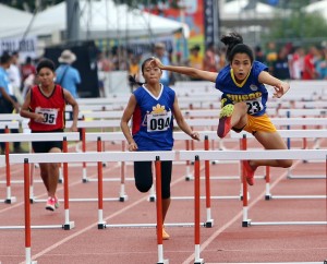 Elyzza May Salinas of Central Visayas leads the pack in the qualifying heat of the 100-meter hurdles for secondary girls at the Davao del Norte sports complex in Tagum City.  CDN PHOTO/LITO TECSON