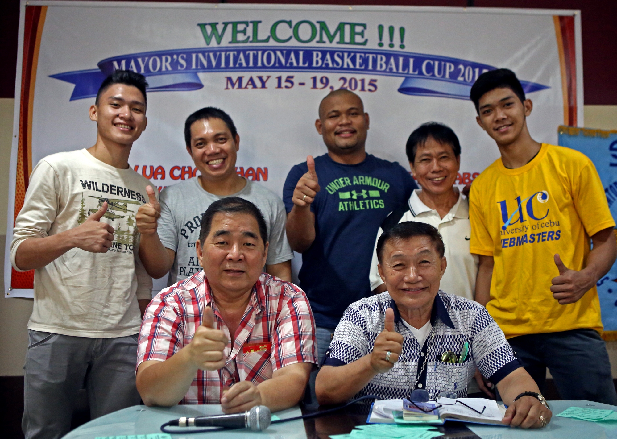 Chao Sy and Bobby Inoferio (seated front row) at the (left to right) Clint Suelto UC point guard,Britt Carlo Reroma USC Coach,Joever Samonte UC Coach,Danny Catingub UC Asst. Coach and John Calvin Jabello show thumbs up for their Mayors Invitational Basketball Cup 2015 these coming May 15-19 at La Fortuna hotel.
