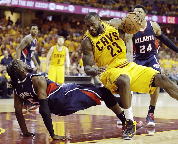 Cleveland Cavalier's Lebron James (23) runs over Atlanta Hawk;s DeMarre Cerroll during the second half of Game 3 of the East Finals. 