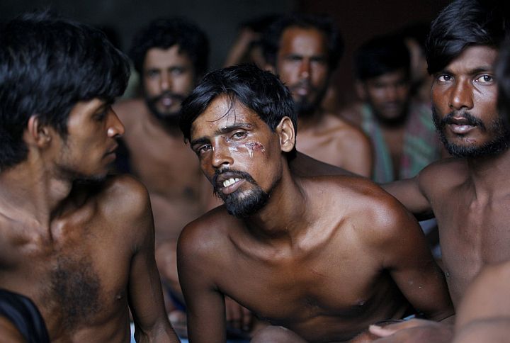 Bangladeshi migrants sit inside a temporary shelter upon arrival at Kuala Langsa Port in Langsa, Aceh province, Indonesia, Friday, May 15, 2015. Hundreds of Bangladeshi and ethnic Rohingya migrants have landed on the shores of Indonesia and Thailand after being adrift at sea for weeks, authorities said Friday. They are among the few who have successfully sneaked past a wall of resistance mounted by Southeast Asian countries who have made it clear the boat people are not welcome. (AP Photo/Binsar Bakkara)