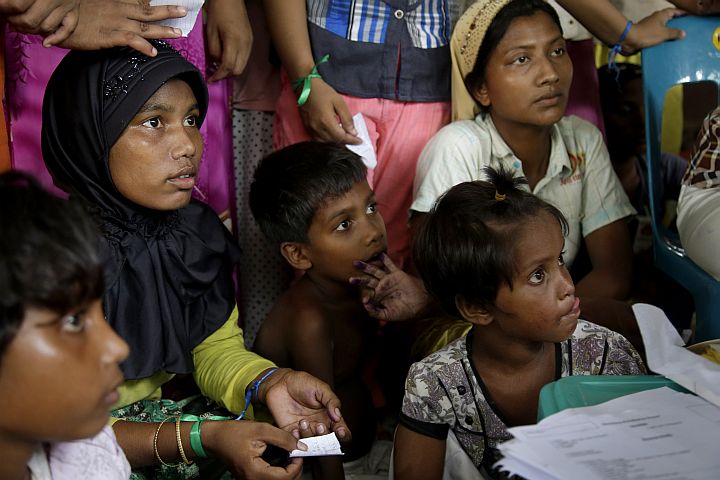 Ethnic Rohingya gather to receive medical treatments at a temporary shelter in Langsa, Aceh province, Indonesia