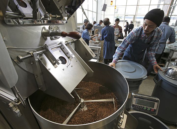 An employee roasts coffee beans at the Blue Bottle Coffe Inc., shop in Tokyo