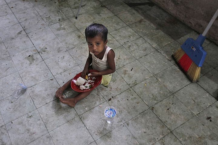 A Rohingya boy eats breakfast at a temporary shelter in Bayeun, Aceh province, Indonesia yesterday.