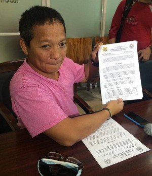 Tinago barangay captain shows the decision of the committee investigating the incident 