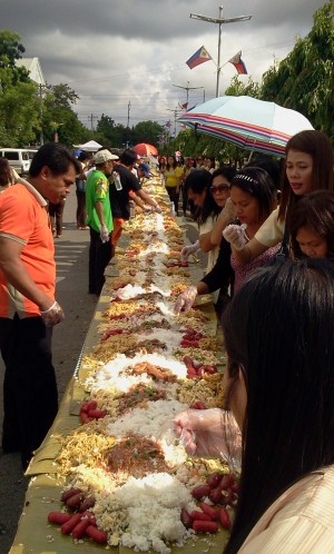 Rice, noodles and other cooked food are laid out on banana leaves for a communal meal called a "boodle fight" at the Lapu-Lapu City Hall grounds for the 54th Charter Day celebration of the city.(CDN/NORMAN MENDOZA)