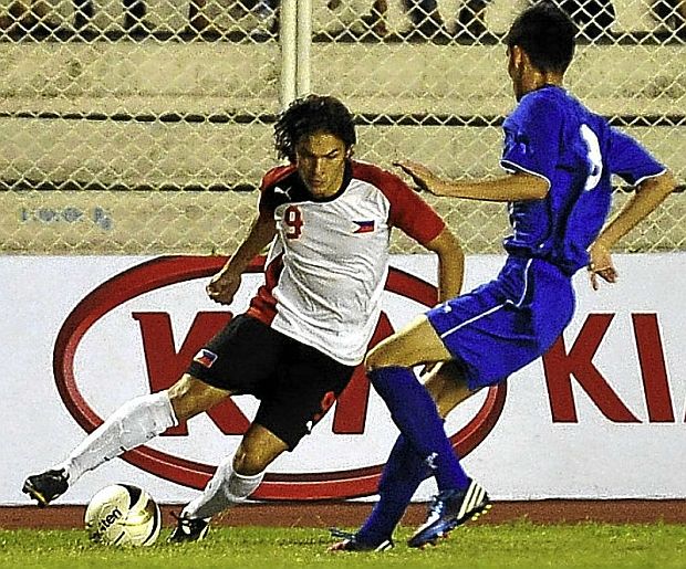 Fil-Iranian Misagh Bahadoran (left)  tries to maneuver past Guam's Ian Mariano in this pba-online.net file photo. The hero of the Philippine Azkals’ successive wins in the FIFA World Cup Qualifiers will visit Cebu this Sunday for the final matches of the 17th Aboitiz Football Cup at the Cebu City Sports Center along with Azkals head coach Thomas Dooley and team manager Dan Palami, bottom left and right, respectively.