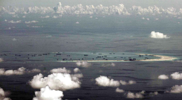 This photo taken from a military plane shows the ongoing reclamation on Mischief Reef, one of the reefs being claimed by China and the Philippines, in the Spratly Islands, in the South China Sea. (AP FILE PHOTO)