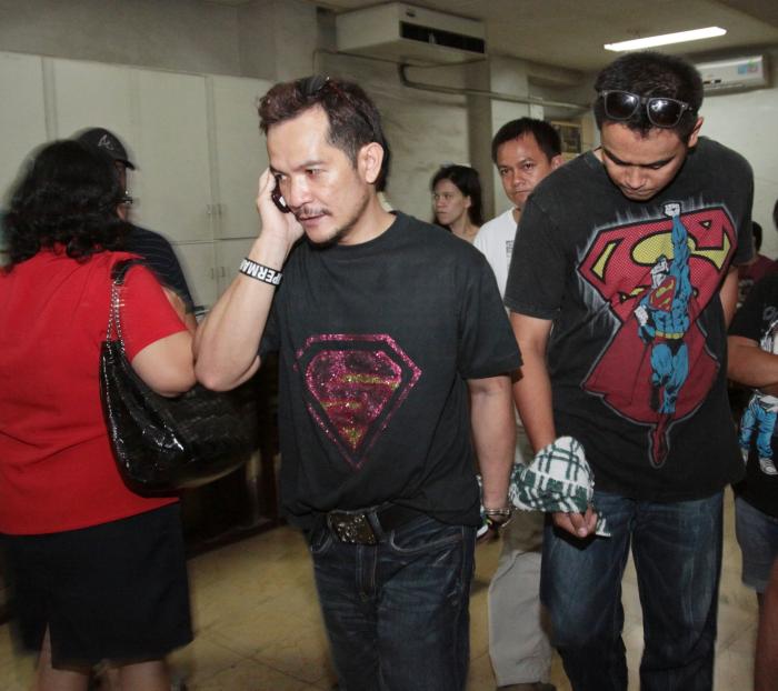 Leodegreco Sanchez (left) son of former vice governor Gregorio Sanchez Jr. is brought to the Palace of Justice with co-accused Edward Teves, following their arrest in a house in barangay Mabolo, Cebu City in this April 15, 2013 file photo.