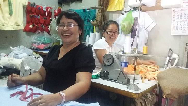 Diome Turado,55 and her friend turned business partner Flor Plarido,53 in just another day in their stall at the heart of Ramos Public Market, doing what they do best which is tailoring. (CDN PHOTO/ APPLE TAAS)