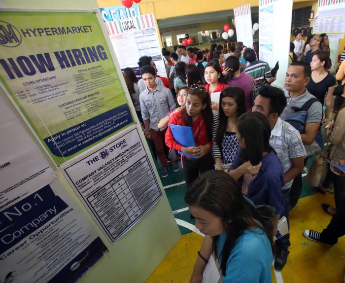 Hundreds of job-seekers look over the job openings listed at the 70th Mega Local jobs Fair in Cebu City Sports Center. (CDN PHOTO/ JUNJIE MENDOZA)