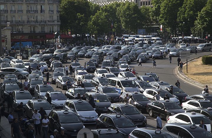 Taxis gather at a major entrance to Paris yesterday. French taxis are on strike around the country, snarling traffic in major cities and slowing access to Paris’ Charles de Gaulle airport after weeks of rising and sometimes violent tensions over Uber.  /AP