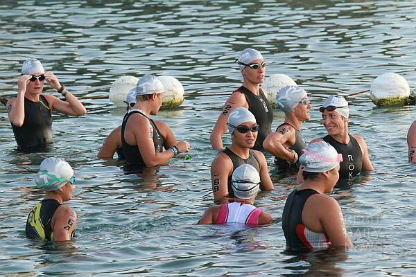 Professional female triathletes enjoy each others company in the water before the gun start. (CDN PHOTO/ JUNJIE MENDOZA)