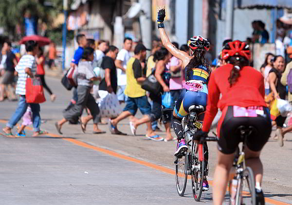 Triathlete shout at the uncontrolable crowd of the Cobra Ironman 70.3 as they pass on corner Plaridel St and AC Cortes ave in Mandaue City.(CDN PHOTO/TONEE DESPOJO)
