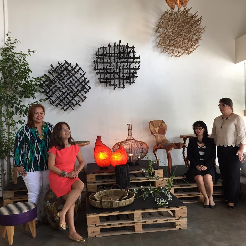 Some of the 'HoliCow' designers pose for a photo with some of their exhibit at the showroom. (CDN PHOTO/ VANESSA LUCERO)