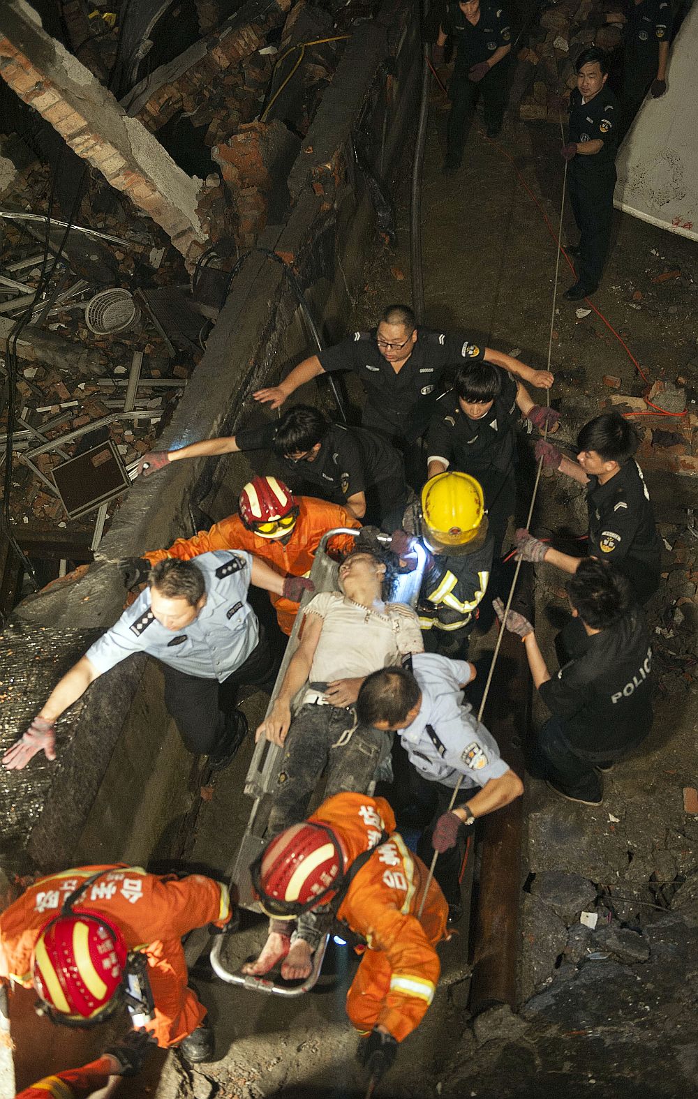  Rescuers use a stretcher to evacuate a victim from the rubble of a factory building in Wenling city in eastern China’s Zhejiang province. (AP)