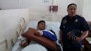 PO1 Demar Muaña thankful for his second life after his old cellphone unit have blocked a bullet that could have penetrated to his chest. He was visited by Senior Supt. Noel Gillamac to extend financial help. (CDN/APPLE MAE TA-AS)