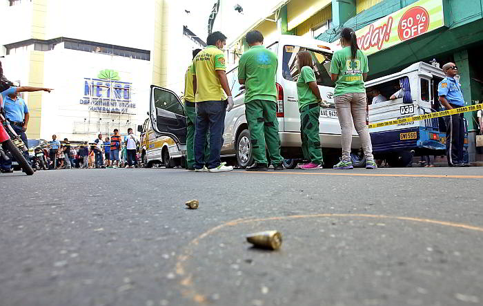 Empty shells of an unknown caliber scatter on the road near the crime scene in Osmeña Boulevard. (CDN PHOTO/ LITO TECSON) 